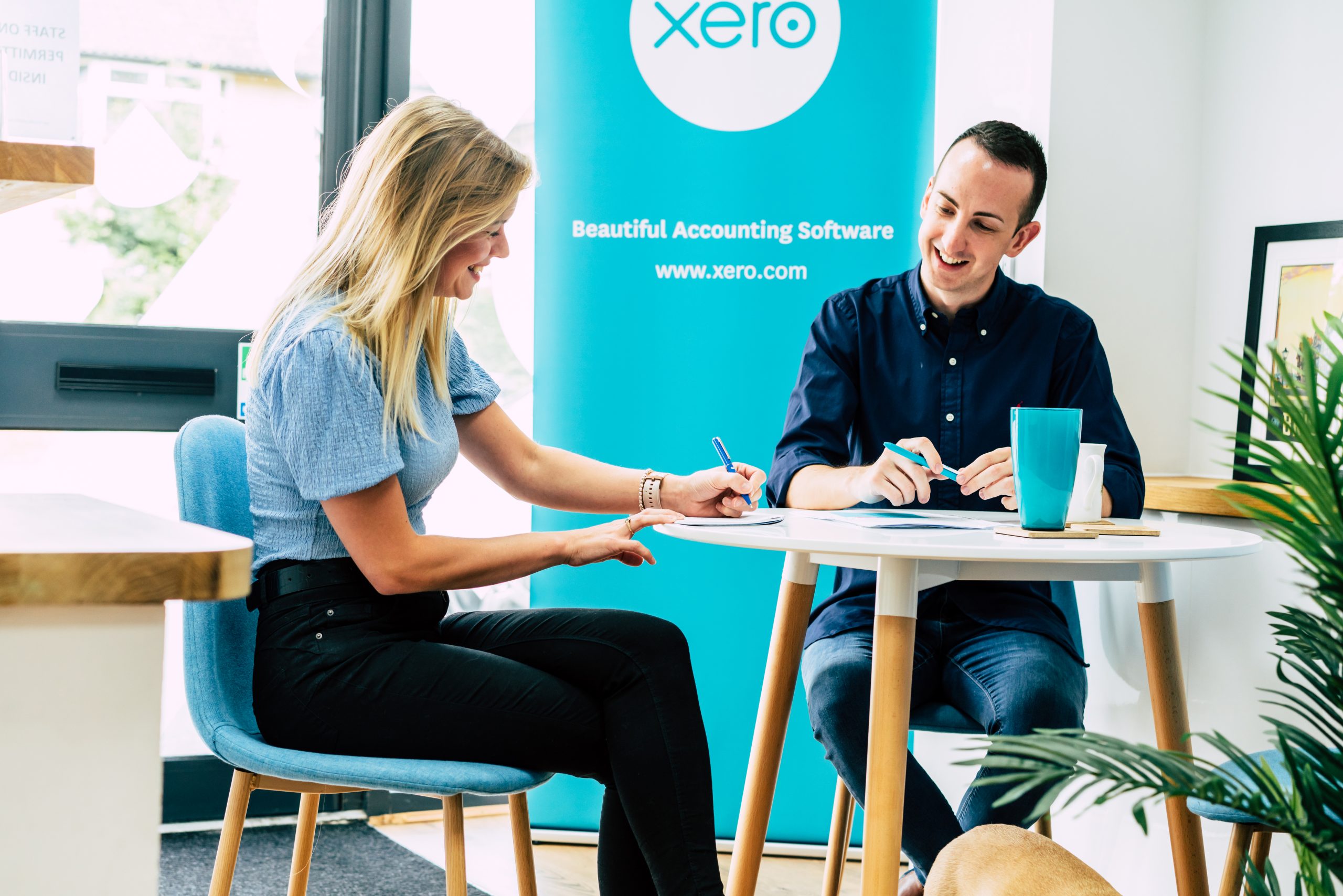 accountant and client worked in front of Xero software backdrop